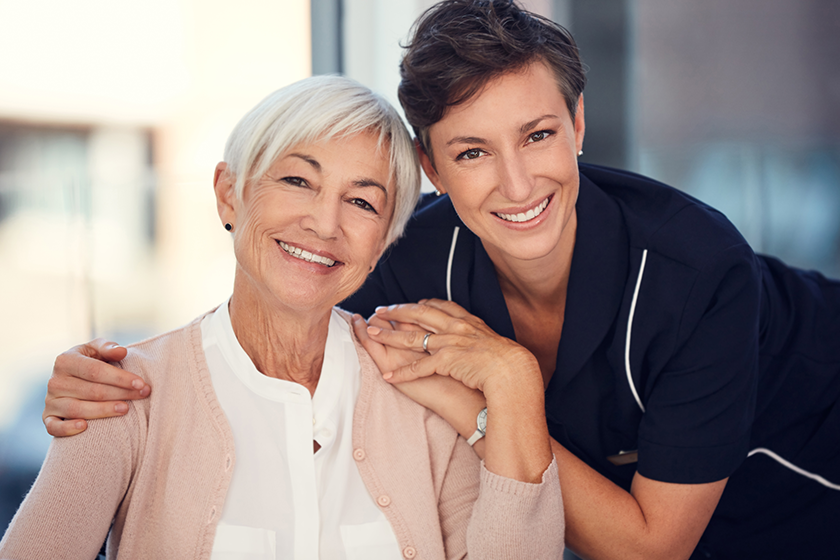 I have a pillar of strength in her. Cropped portrait of a young female nurse embracing a senior woman sitting in a wheelchair in a nursing home. 