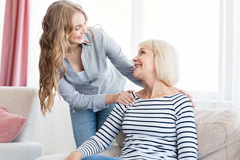 Positive woman and her daughter resting at home