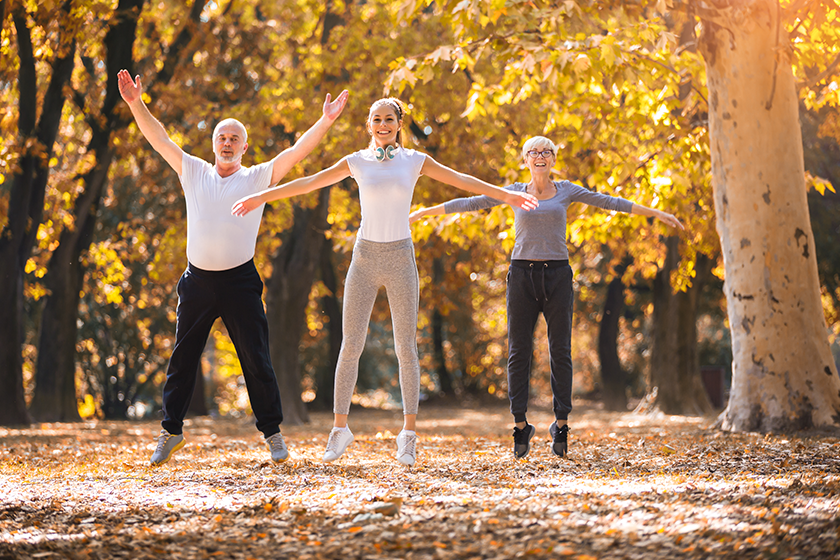 Senior man and woman and young female instructor workout on fresh air. Outdoor activities, healthy lifestyle, strong bodies, fit figures. Stylish, modern sportswear. Different generations 